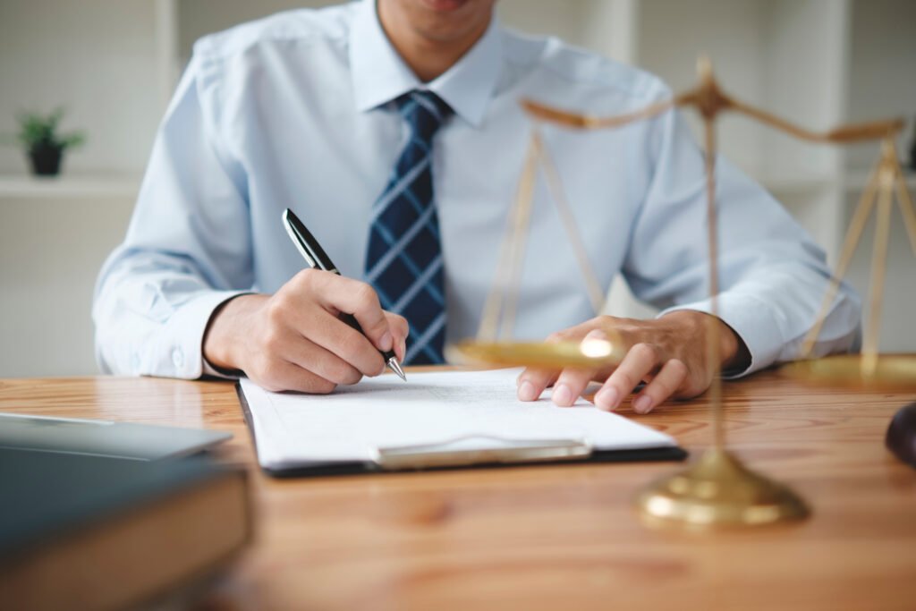 man signing document