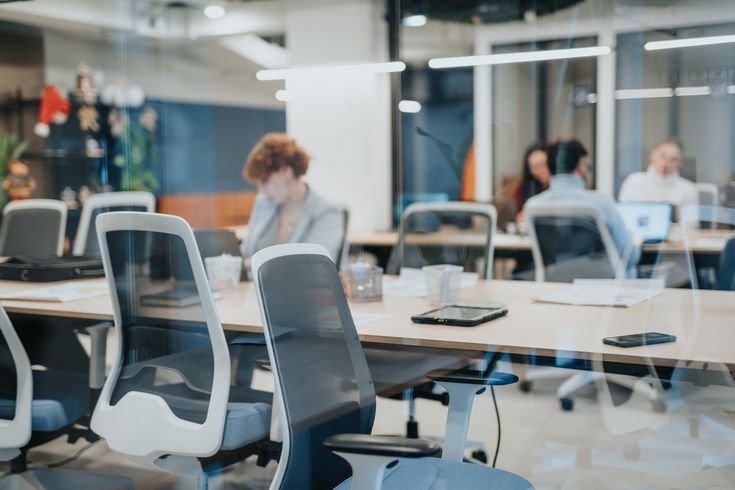 Oglet No Win No Fee solicitors: Workers in an open plan office working at their desks.