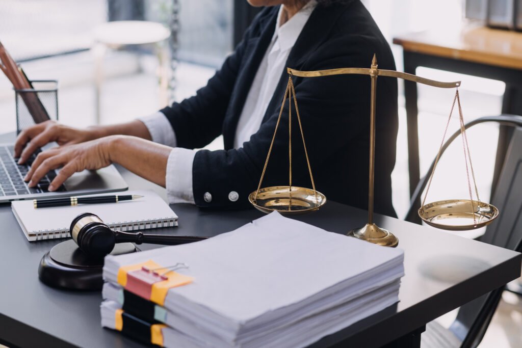 man sat at desk with pile of paperwork