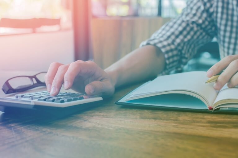 A solicitor uses a calculator to help value compensation