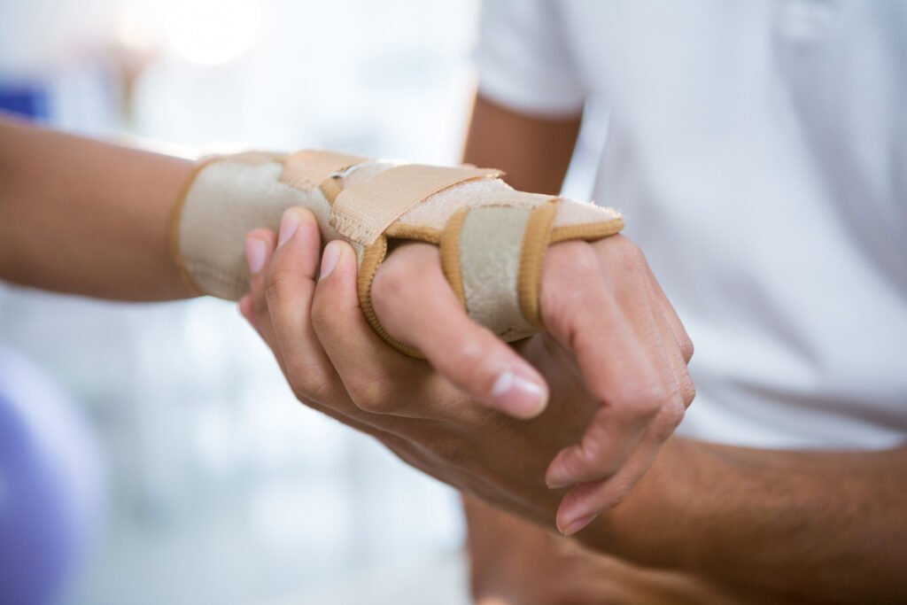 Person stressed about injured hand and wanting to make wrist injury claim
