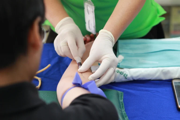 A blood test being performed by a doctor.