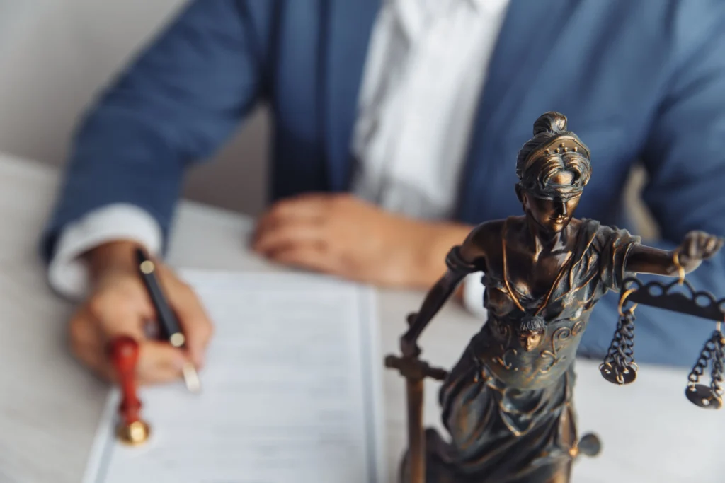 A solicitor taking notes a desk with a statue of liberty in the foreground